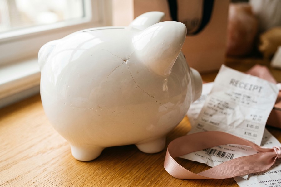 Calculator and notebook showing a person computing their financial freedom number goal