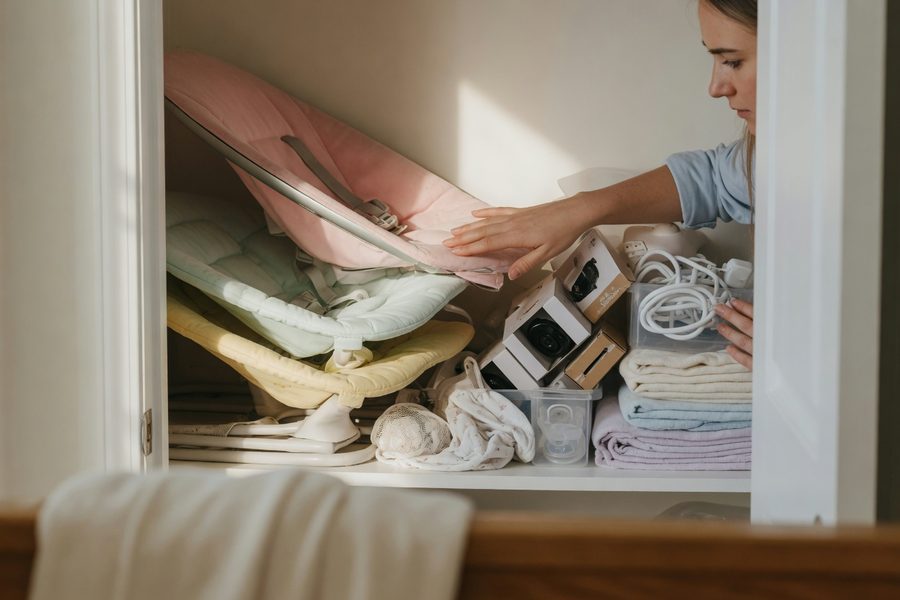 Secondhand baby clothing organized in a closet, proving near-new quality