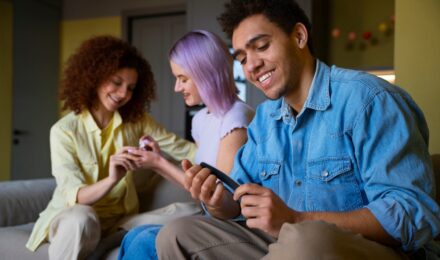 Teens using savings apps on smartphones with FDIC-insured accounts