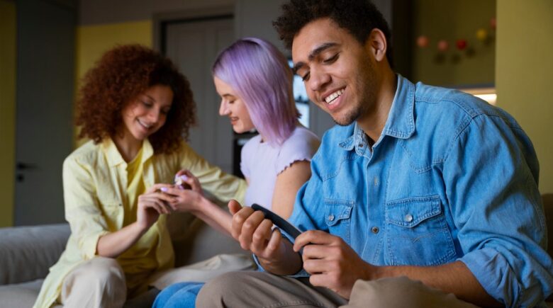 Teens using savings apps on smartphones with FDIC-insured accounts