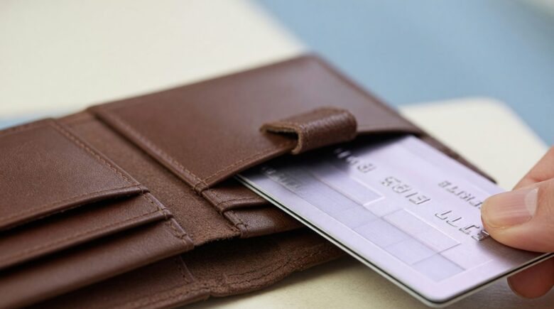 Business owner reviewing business credit card statement for expense categorization