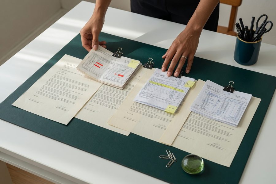 Credit dispute letter with highlighted errors and supporting documents on a desk.