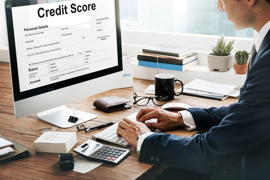 A landlord reviewing a credit score rental application on a tablet