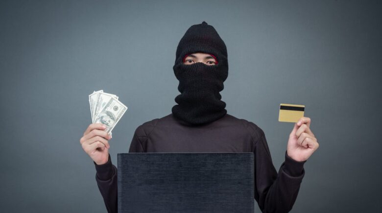 Person reviewing financial statements and security alerts on a laptop to protect against fraud