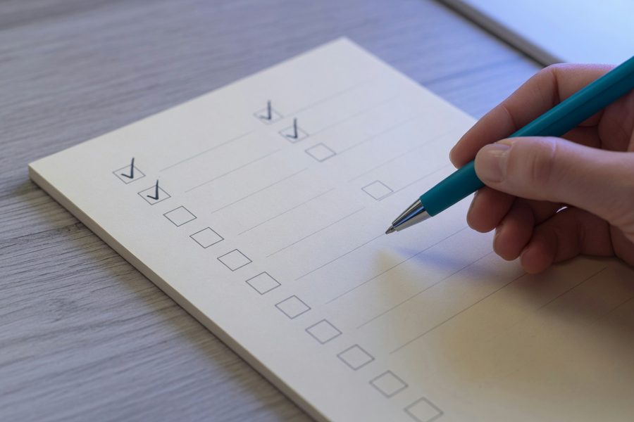 A family reviewing their grocery receipt and discussing which store‑brand swaps to make next week