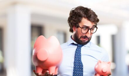 Person setting up automatic savings to build an emergency fund