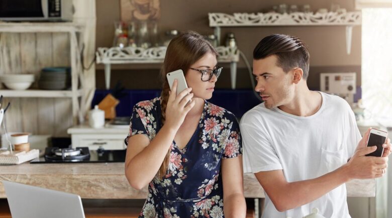 Married couple reviewing credit reports and financial documents together at home