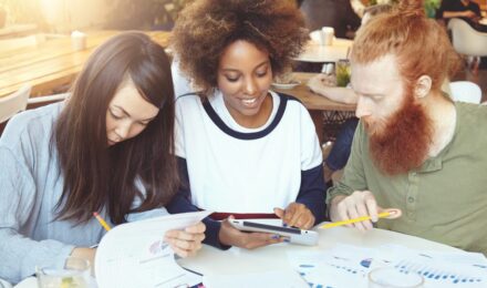 Young professional reviewing budget and financial plan at desk