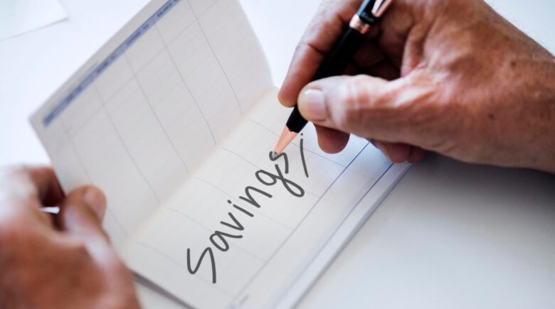 A person reviewing their budget and savings goals on a laptop, with a calendar and financial planning notes nearby