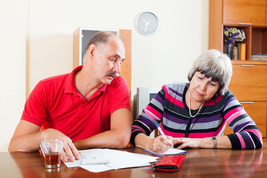 Retiree reviewing medical expense receipts and tax deduction records