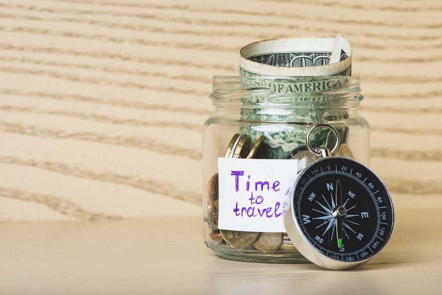 Person reviewing a vacation savings tracker on a smartphone budgeting app
