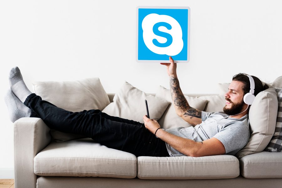 A person reviewing a credit card statement on a laptop with subscription logos floating around