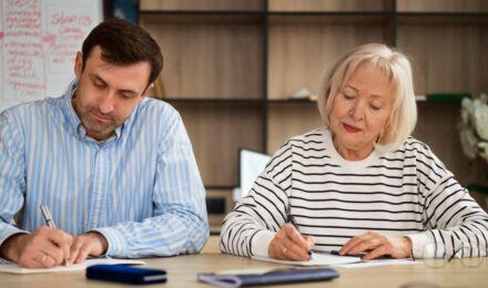 Teacher reviewing pension documents and retirement income plan at desk