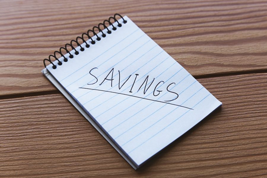 Image: A Texas resident reviewing a savings account dashboard showing 5.2% APY vs. 0.45% national average