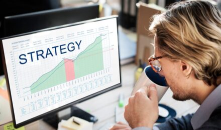 A person reviewing a savings plan with a spreadsheet and two bank accounts