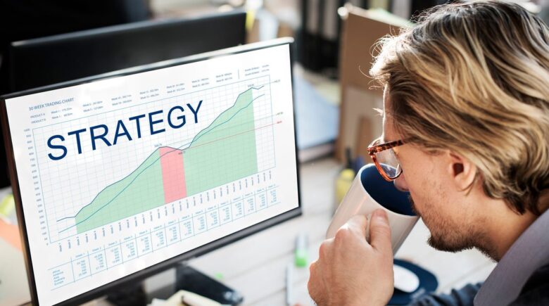 A person reviewing a savings plan with a spreadsheet and two bank accounts