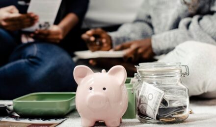 Person reviewing financial documents with a focus on savings vs investments