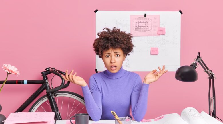 A person reviewing a car repair bill while holding a credit card and considering payment options